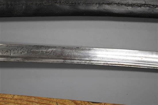 An Indian sword tulwar, silver decorated iron Lahori hilt, blade with etched inscription, 18th century, leather covered scabbard,